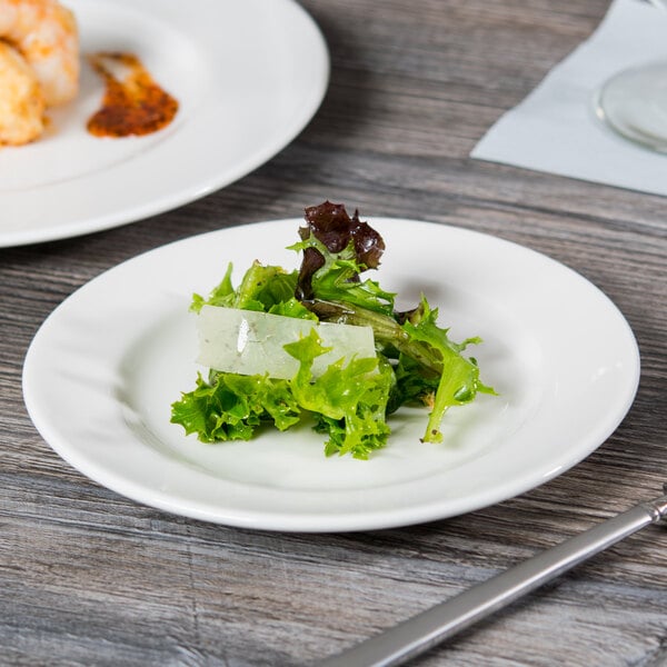 A Libbey white porcelain plate with food on it.