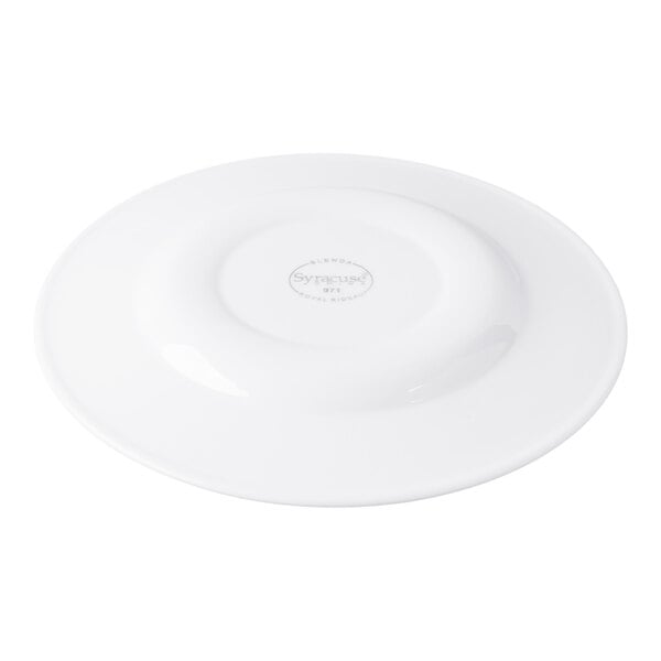 A white porcelain plate shown upside down with a visible maker's mark in the center.
