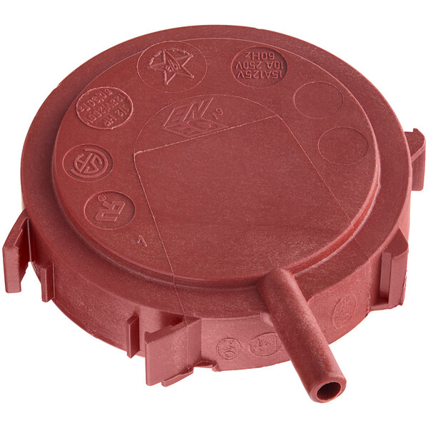 A red round plastic cap with a couple of holes.