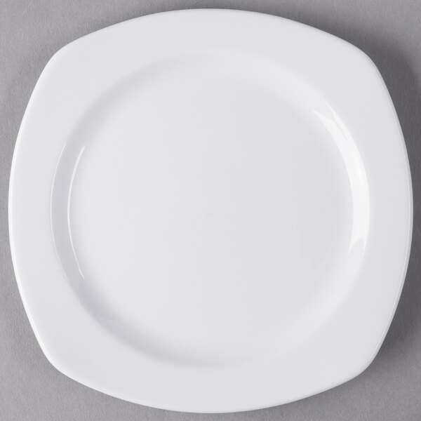 A white Libbey porcelain plate with a small rim on a gray surface.