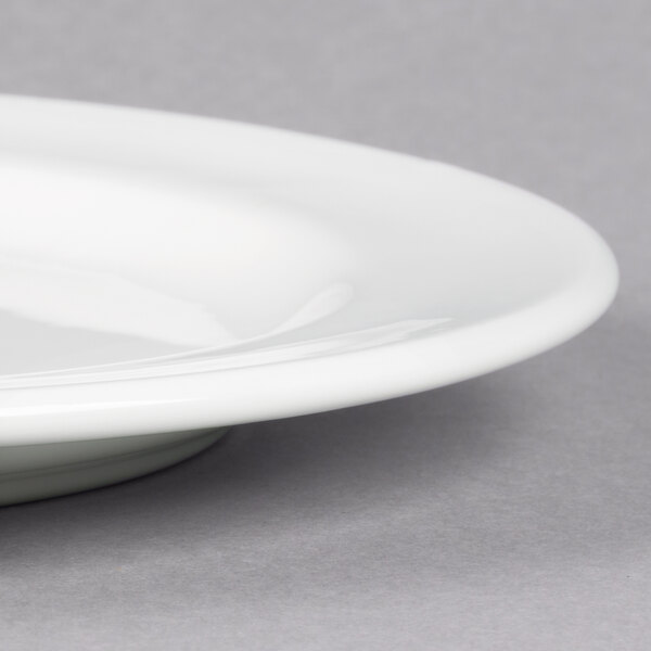 A close up of a Libbey white porcelain plate with a medium rim.