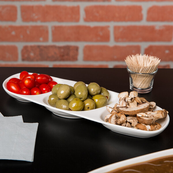 A white Libbey porcelain serving tray with three wells of food.