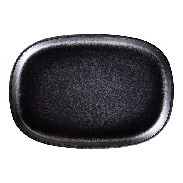 A black oval RAK Porcelain Forge plate with a black rim.
