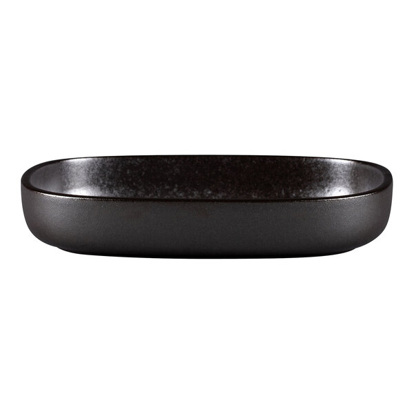 A black oval RAK Porcelain Forge deep plate with a black rim.