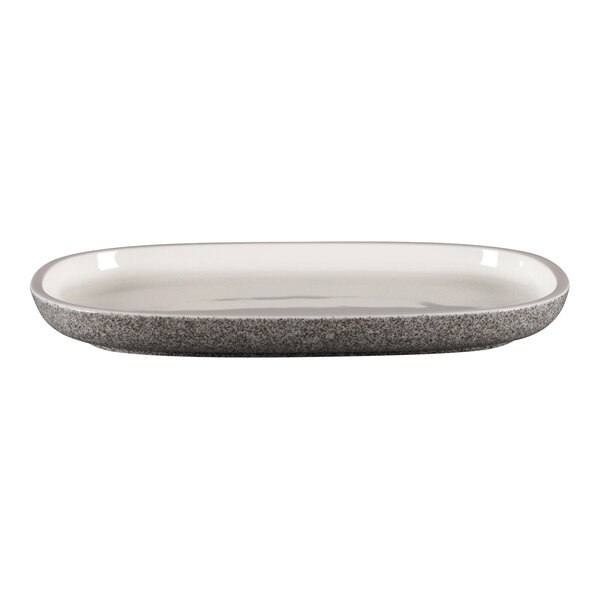 A white oval porcelain plate with a grey speckled rim.