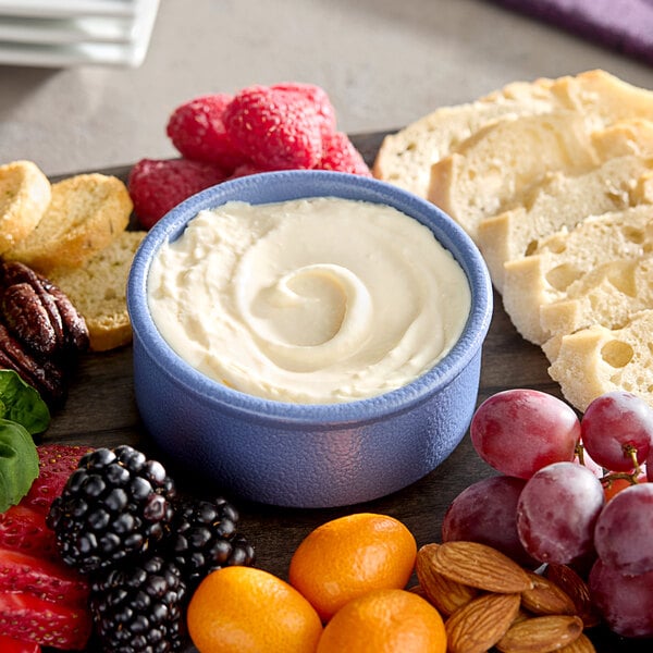Sliced bread next to a bowl of Eiffel Tower Brie Cheese Spread.