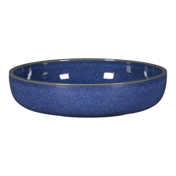 A RAK Porcelain cobalt blue deep porcelain plate with a rim on a table.