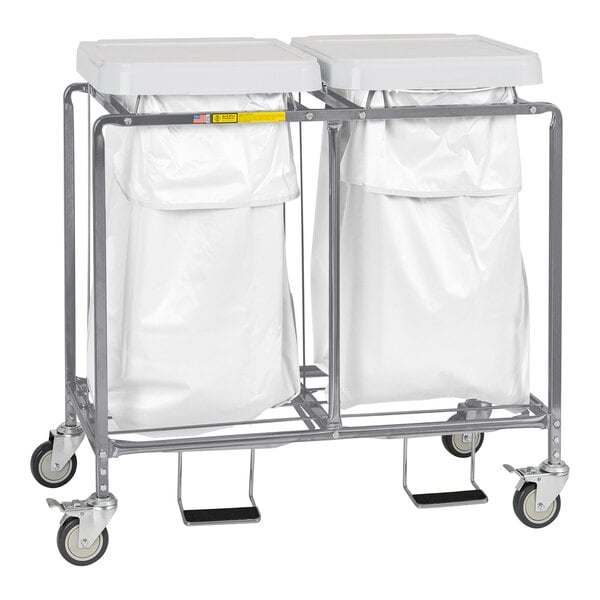 A white Deluxe Double Leakproof Hamper on wheels with two white bags.