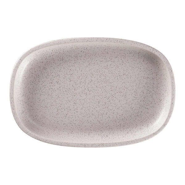 A close-up of a white speckled RAK Porcelain oval plate.