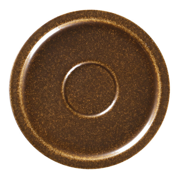 A brown porcelain saucer with a circle in the middle.