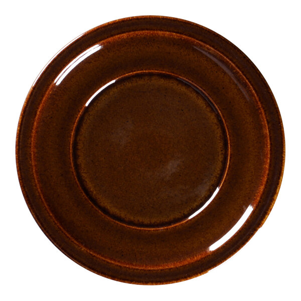 A close up of a brown RAK Porcelain plate with a brown rim.