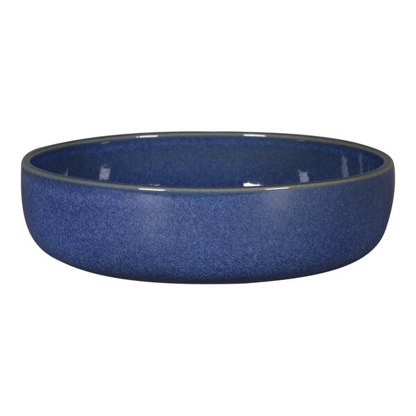A close-up of a RAK Porcelain cobalt blue bowl with a speckled rim.