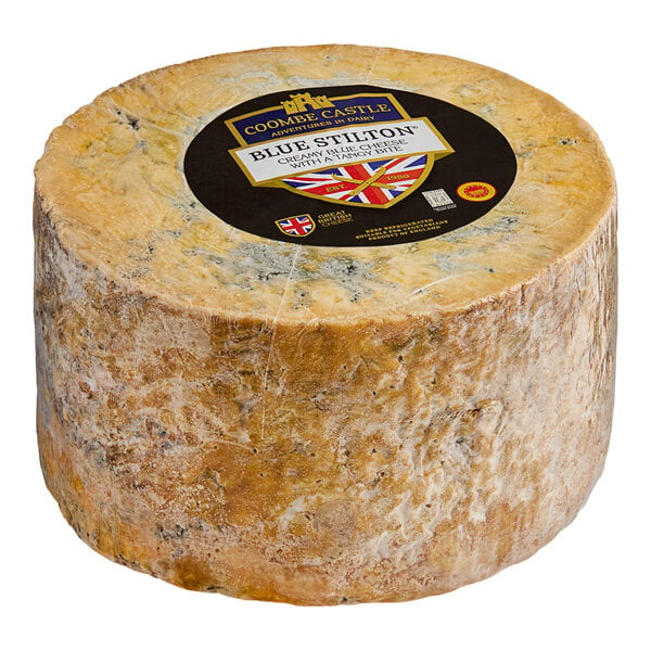 A Coombe Castle Blue Stilton cheese wheel with a label.