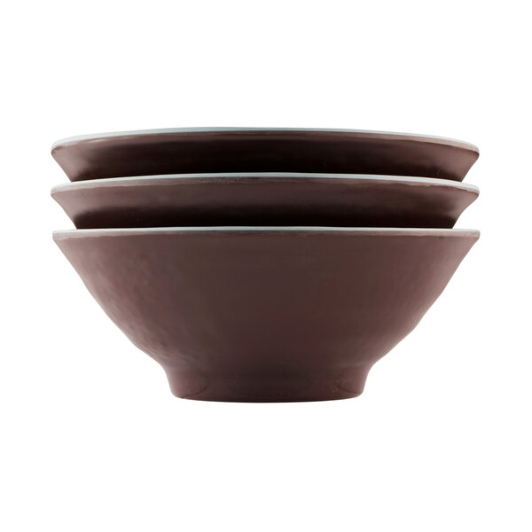 Three Elite Global Solutions Abyss-colored melamine bowls with black and brown designs stacked on top of each other.