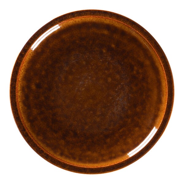 A close-up of a brown RAK Porcelain flat coupe plate with a white background.