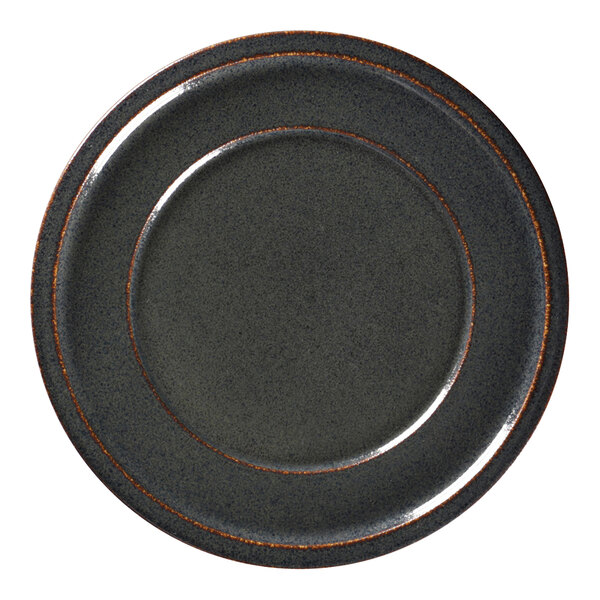 A close-up of a black RAK Porcelain plate with a brown rim.