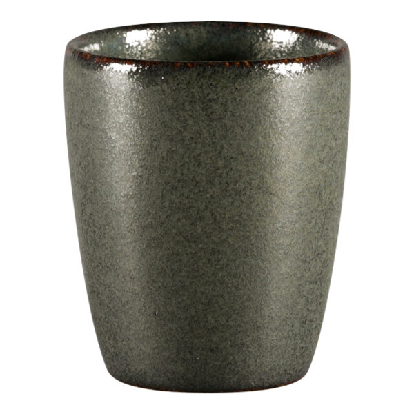A close-up of a RAK Porcelain green espresso cup with a black rim.