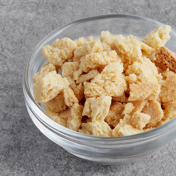 A bowl of crumbled pie crust pieces on a table.