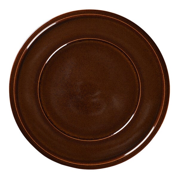 A brown RAK Porcelain plate with a gold rim.