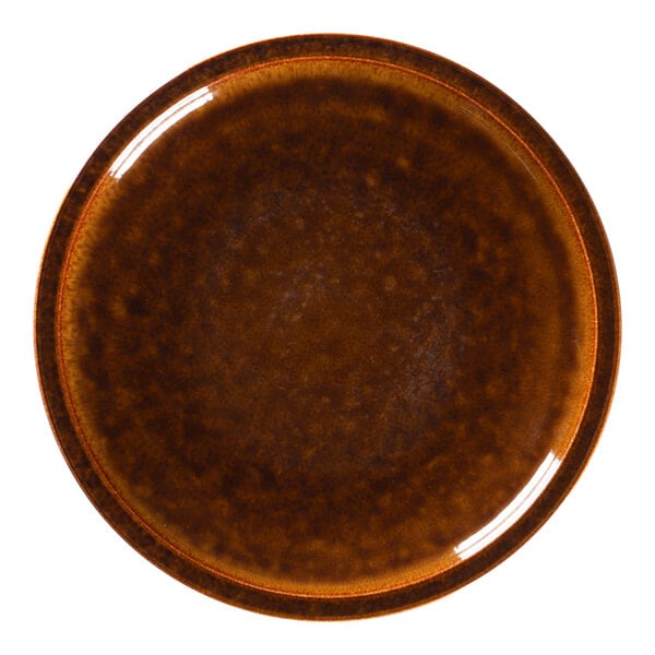 A close-up of a brown RAK Porcelain plate with a brown rim.