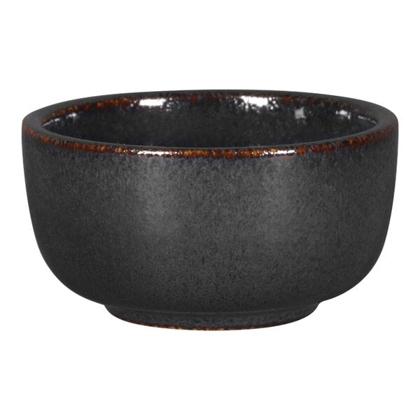 A black RAK Porcelain ramekin with brown speckles on the rim.