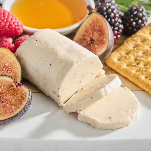 A plate of Celebrity Goat Fig goat cheese with crackers and a fig.
