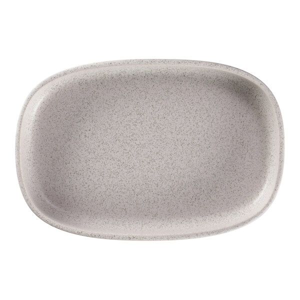 A white oval RAK Porcelain plate with speckled design.