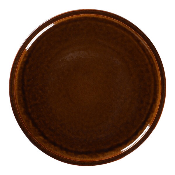 A close-up of a brown RAK Porcelain plate with a white background.