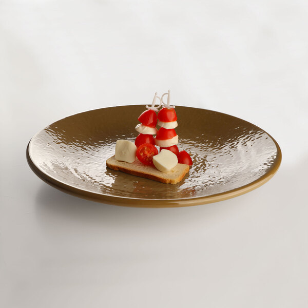 A tapenade-colored Elite Global Solutions round plate with food on it.