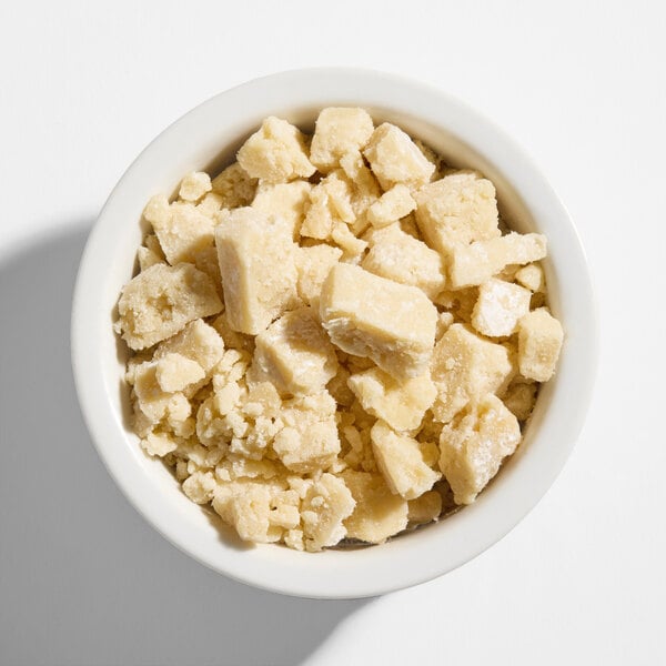 A bowl filled with chunky pieces of gooey butter cake.