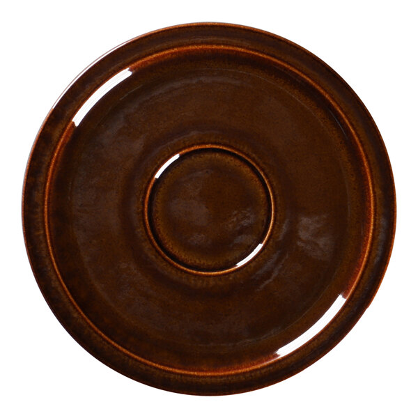 A close-up of a brown porcelain saucer with a circle in the middle.