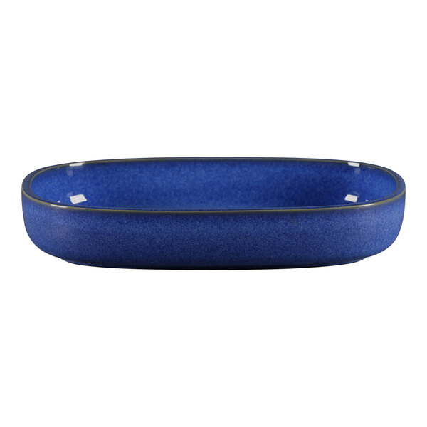 A blue oval porcelain serving dish with a black rim.