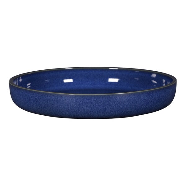 A blue porcelain plate with a black rim.