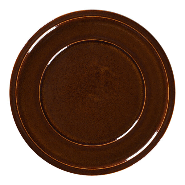 A close-up of a brown RAK Porcelain plate with a rim.