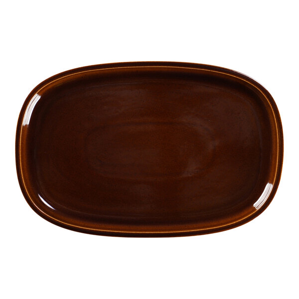 A brown oval porcelain plate with a white background.