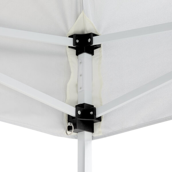 A white tent with black metal brackets.