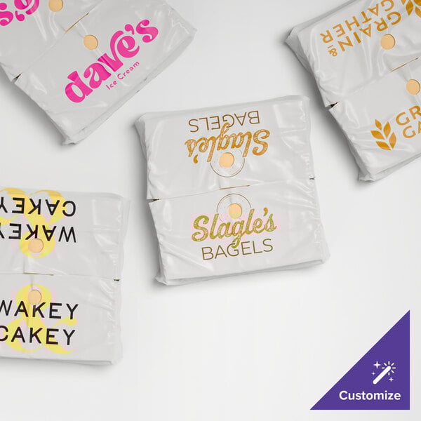 A set of white plastic catering tray bags with various custom printed logos and designs.