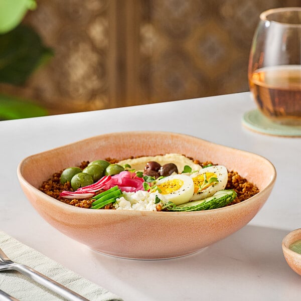 A table set with Acopa Highlands Primrose Peach china bowls filled with food.