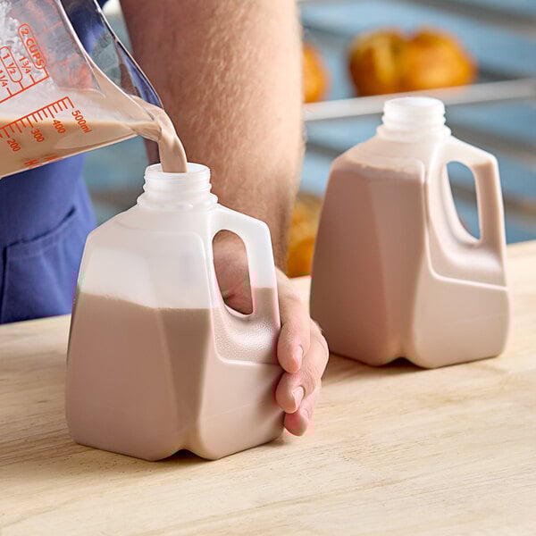A person pouring milk into a Translucent HDPE milk jug.