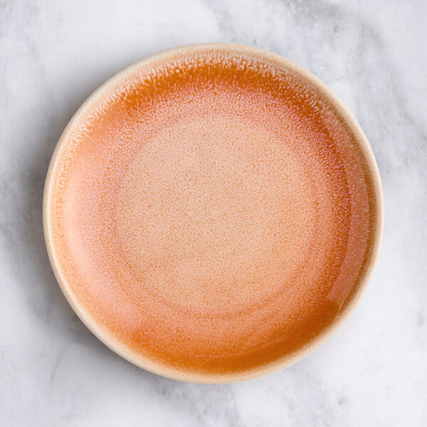 An Acopa Highlands pink coupe china plate with a pink glaze.