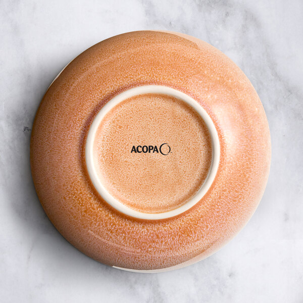 A close-up of an Acopa Primrose Pink bowl with a white circle in the center.