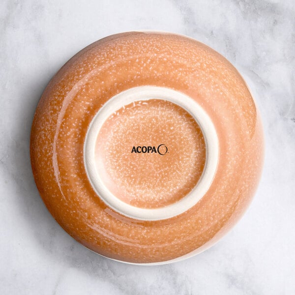 An Acopa Primrose Pink bouillon cup with a white rim and a white circle inside.