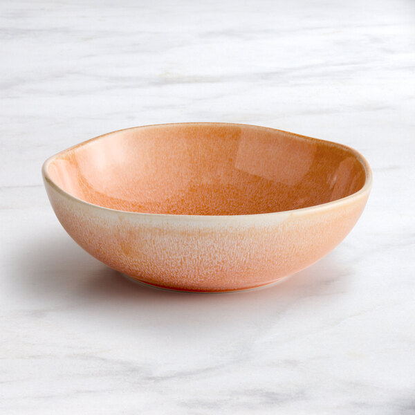 An Acopa Highlands primrose pink china bowl on a marble surface.