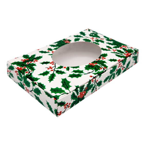 A white Holly Holiday candy box with an oval window and holly leaves on it.