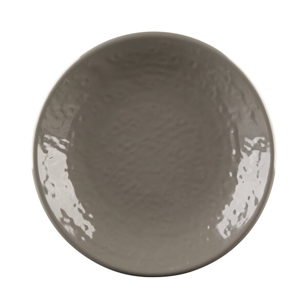 A close-up of a mushroom-colored Elite Global Solutions round plate.