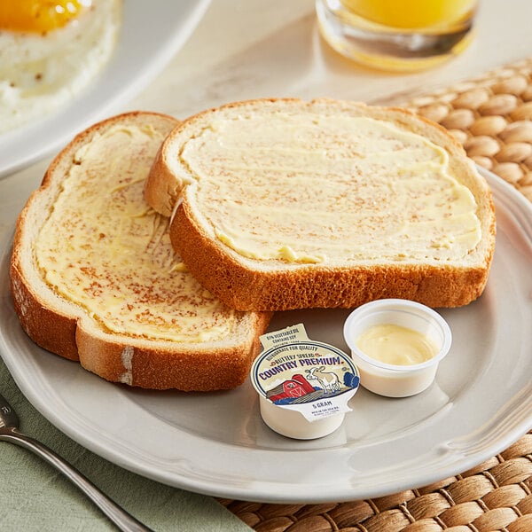 A plate with eggs, toast, and a Bunge Country Premium Buttery Spread portion cup.