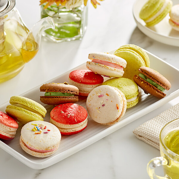 A white plate with a variety of Macaron Centrale vegan macarons on it.