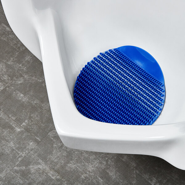 A blue F-Matic urinal screen with a blue rubber pad.