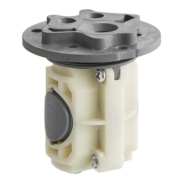 A white plastic American Standard pressure balance cartridge with a black round cover.