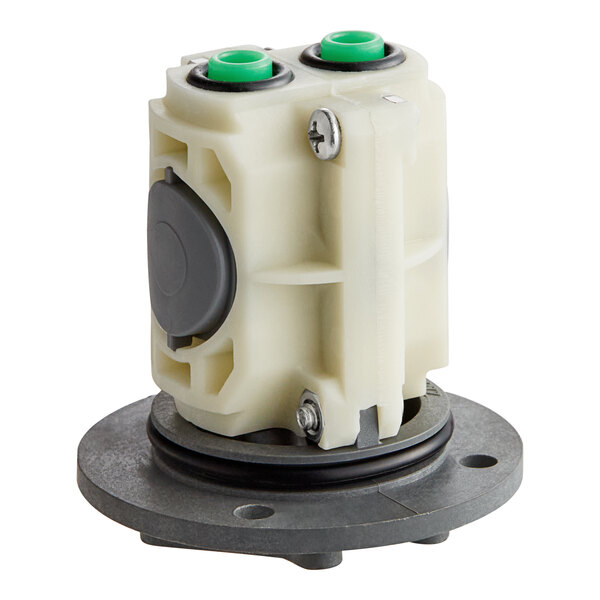 A white plastic American Standard pressure balance cartridge with green buttons.